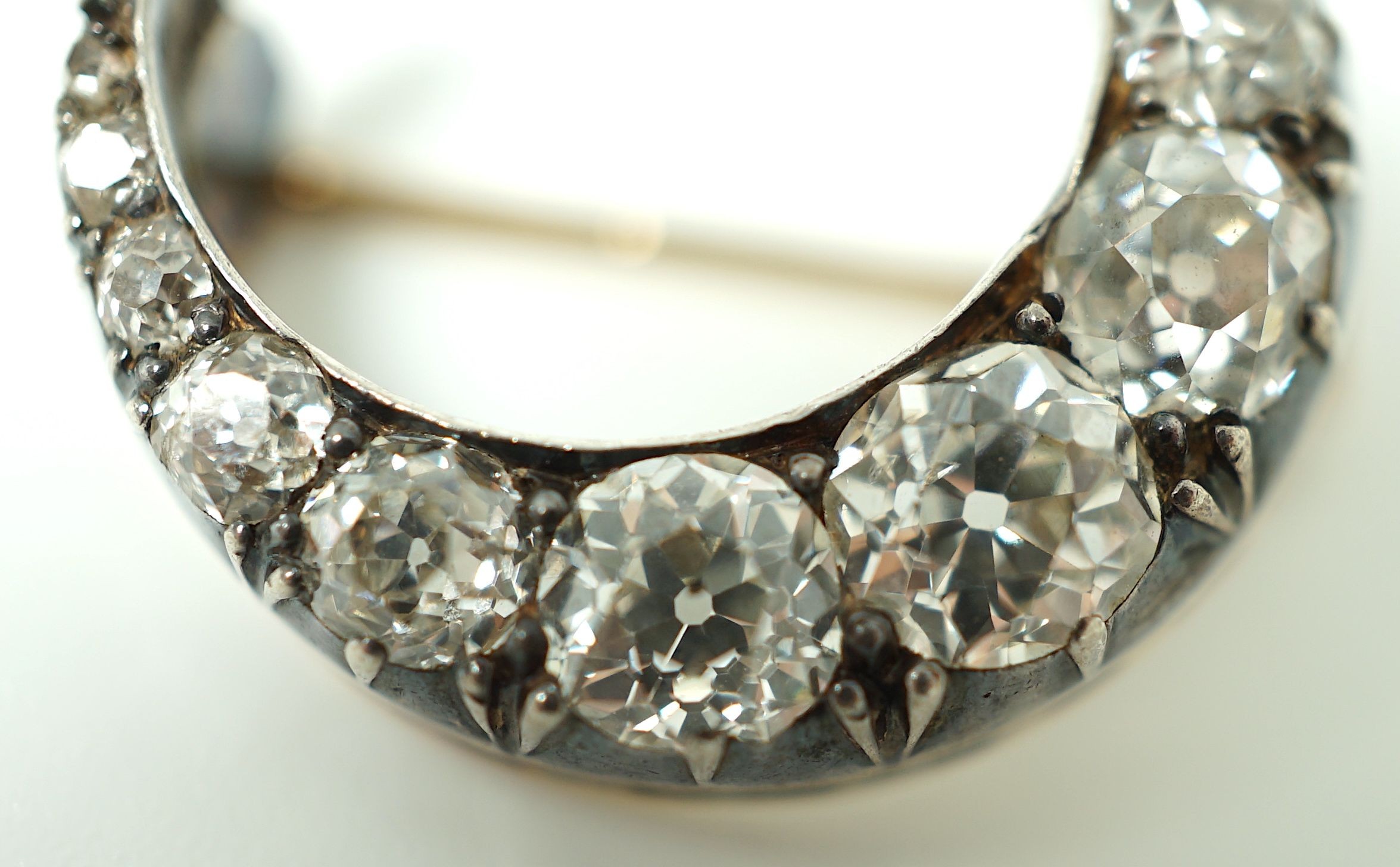A Victorian gold, silver and graduated thirteen stone diamond set crescent brooch